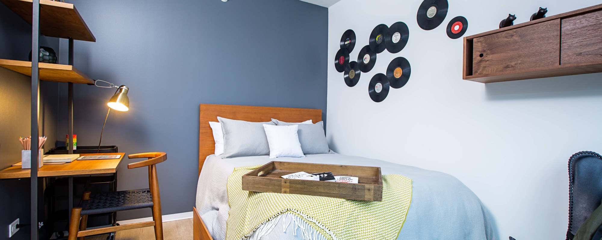 Bedroom with blue accent wall at Exhibit On Superior in Chicago, Illinois