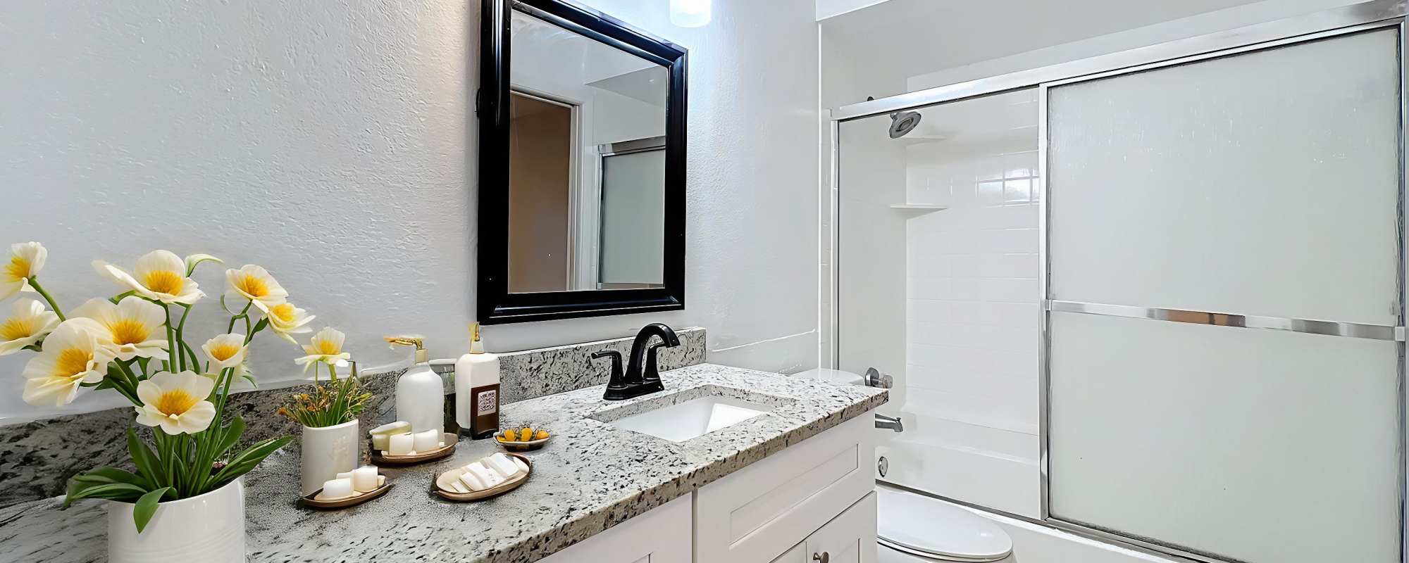 White, well-lit bathrooms at Images Condominiums in Kissimmee, Florida