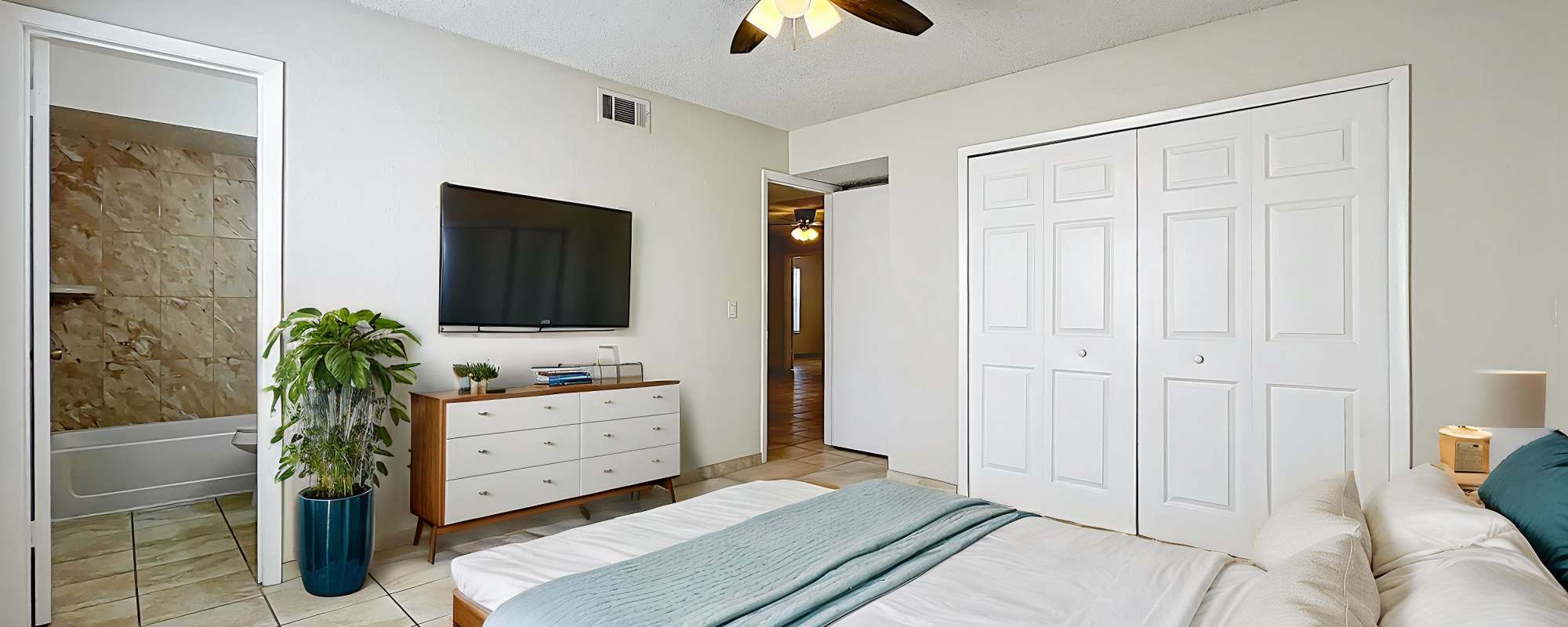 Serene modern bedroom of Images Condominiums in Kissimmee, Florida
