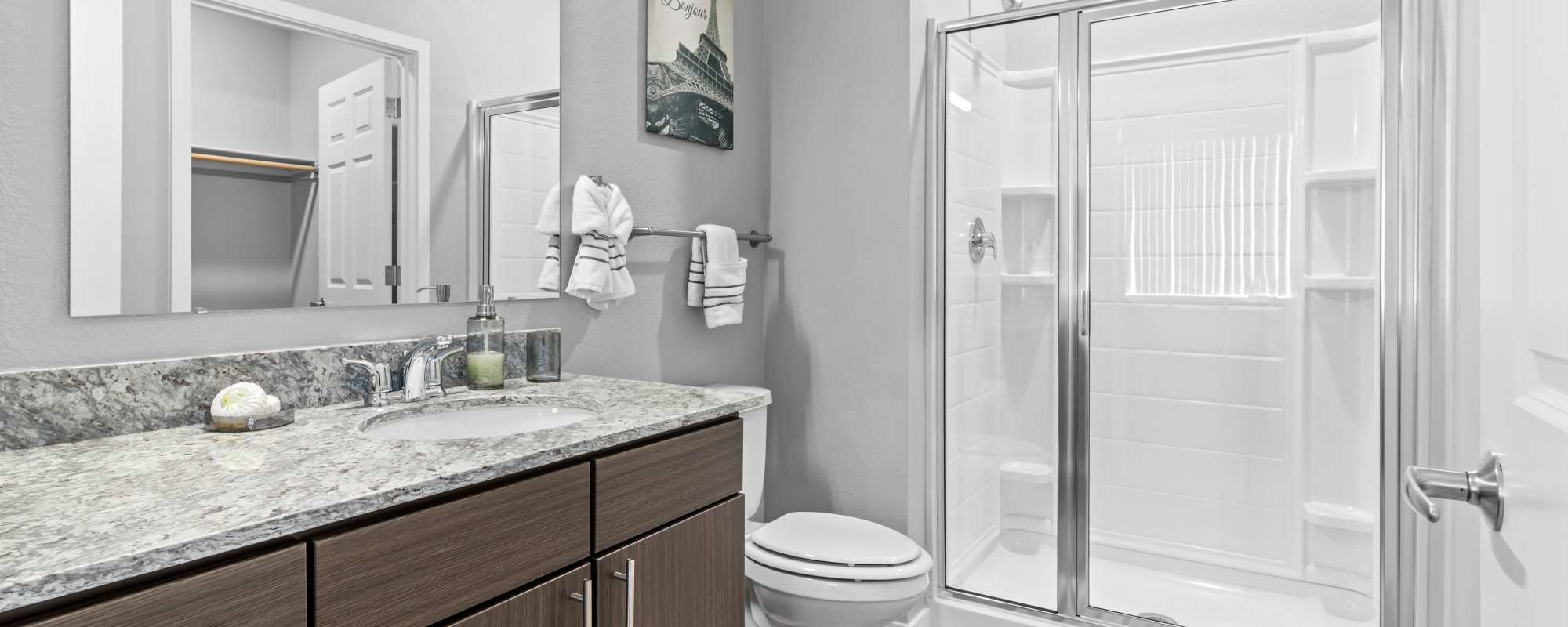 Bright bathroom with a mirror, sink, storage space and shower at VerraWest in Longmont, Colorado