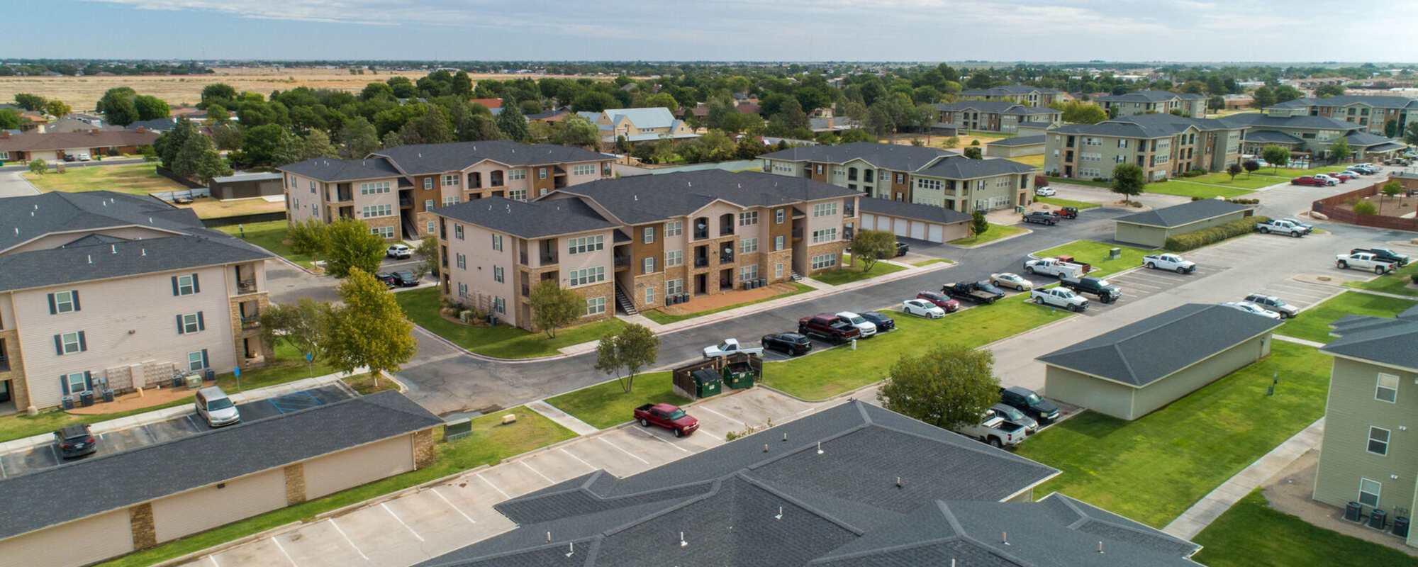Aerial view of the community with parking cars at Windscape Apartments in Hobbs, New Mexico