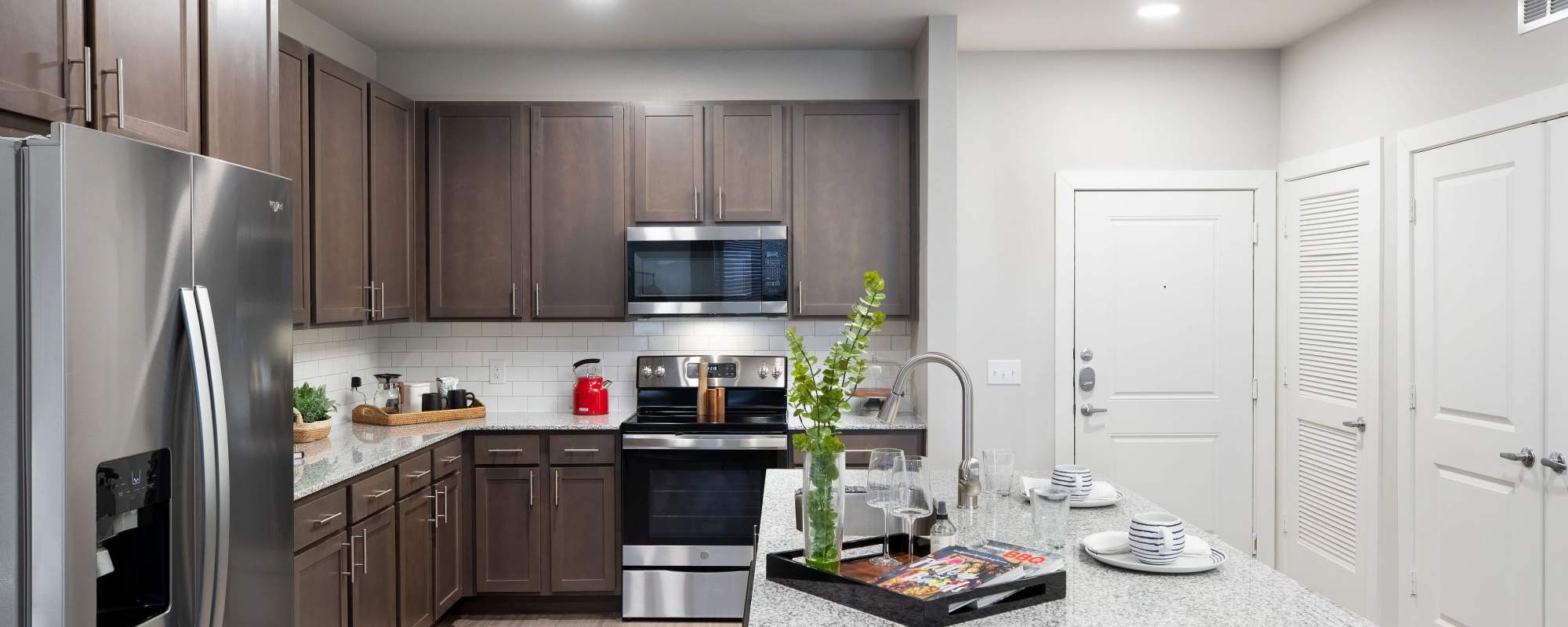 Granite countertops and stainless steel appliances at August Friendswood in Friendswood, Texas