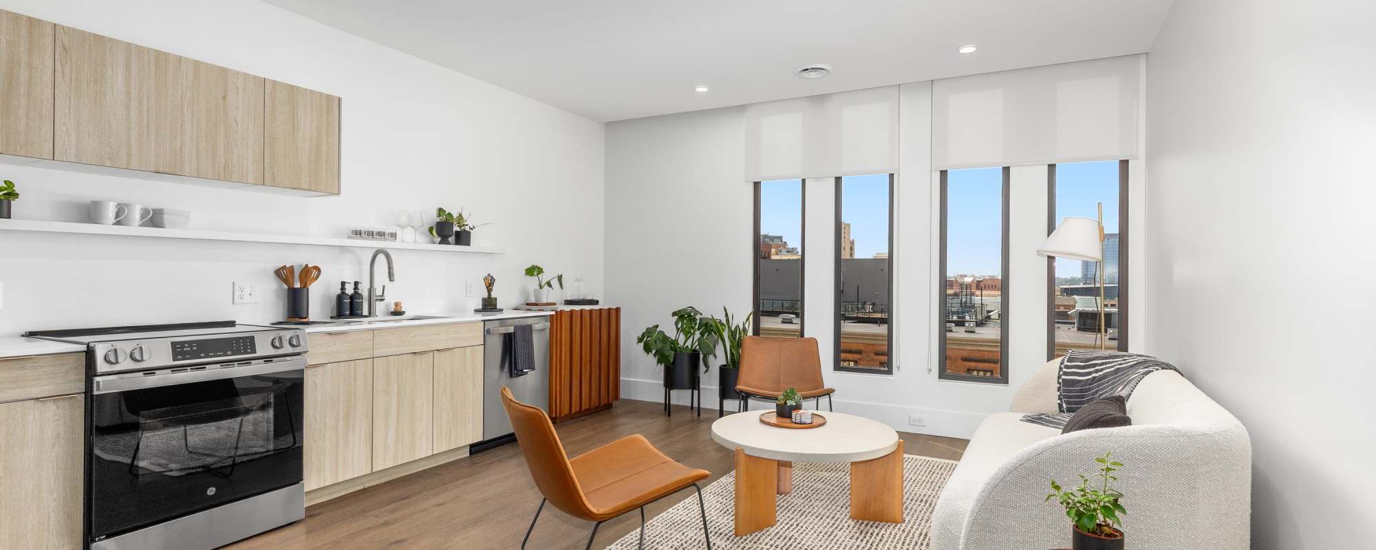 Bright space with wood-style flooring, large windows providing natural light at Residences at 111 Lyon in Grand Rapids, Michigan