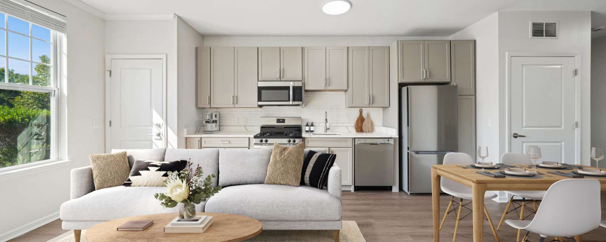 Apartment living and dining room with dining table and sofa seating