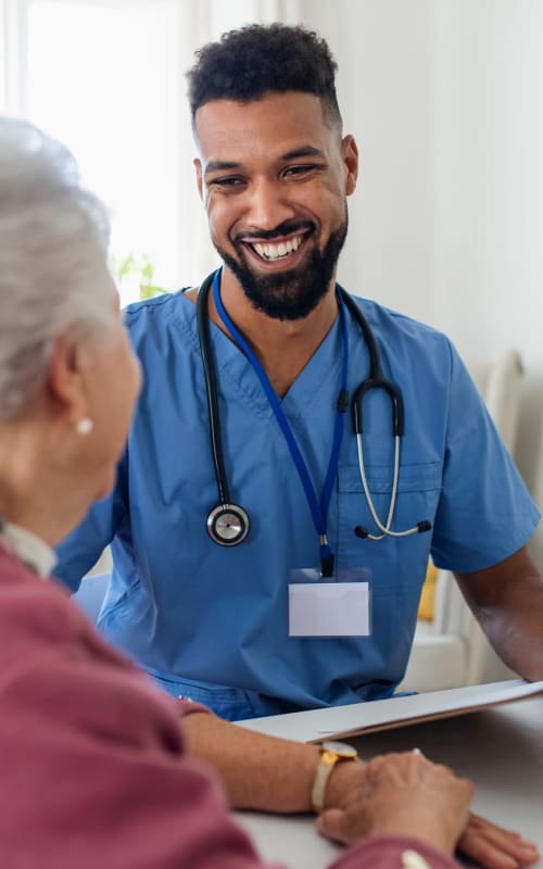 Resident talking with a nurse at Pilot Butte Rehabilitation Center in Bend, Oregon