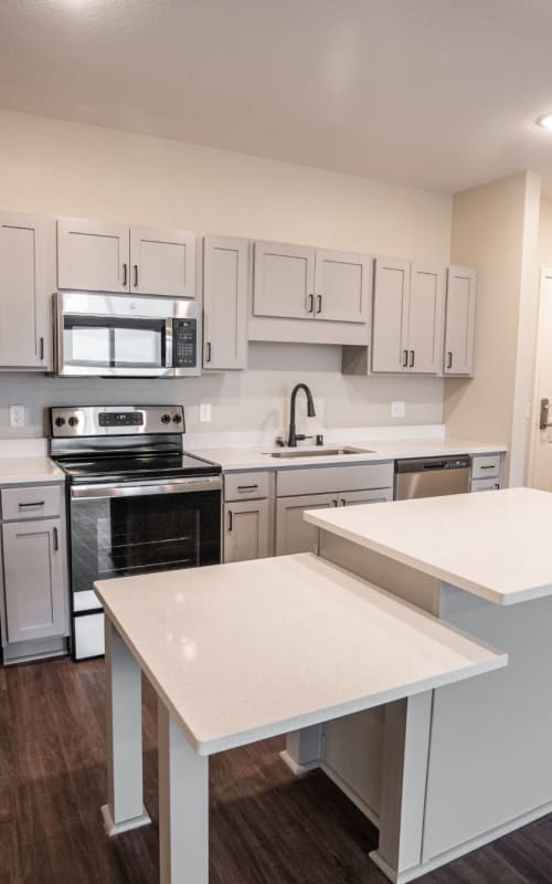 Spacious resident kitchen with stainless steel appliances at The Pillars of Lakeville in Lakeville, Minnesota