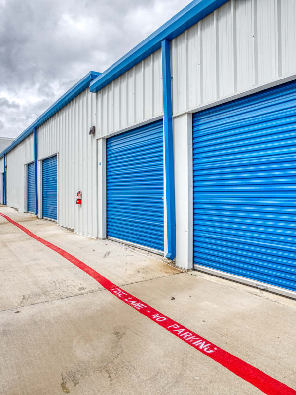 Blue roll-up doors to storage units at Devon Self Storage in Fort Worth, Texas