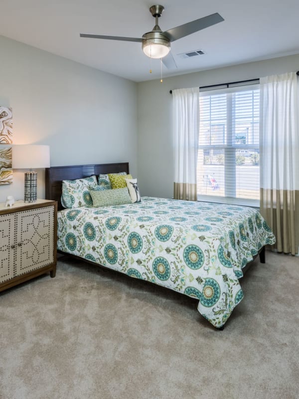 Comfortable bedroom with ceiling fan and open windows at Leland Station in Leland, North Carolina