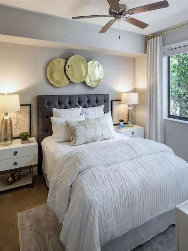 Bedroom with a ceiling fan at Sole at City Center in West Palm Beach, Florida