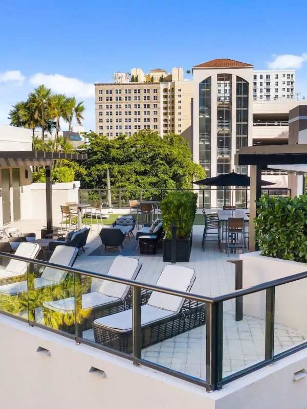 Lounge chairs in the community courtyard at Sole at City Center in West Palm Beach, Florida