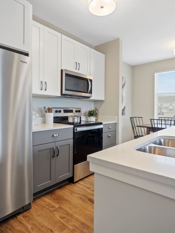 upscale apartment kitchen with stainless steel appliances at Seasons at North Aurora in North Aurora, Illinois