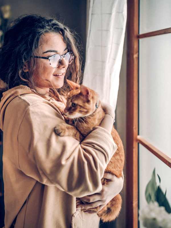 Resident holding her cat in their apartment at Eclipse on Broad in Athens, Georgia