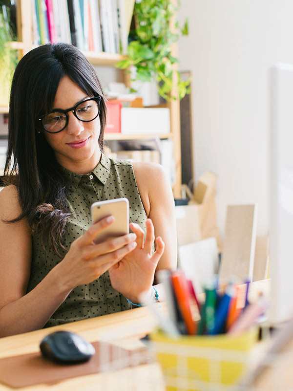 A woman using her phone at Darby Development in Mount Pleasant, South Carolina