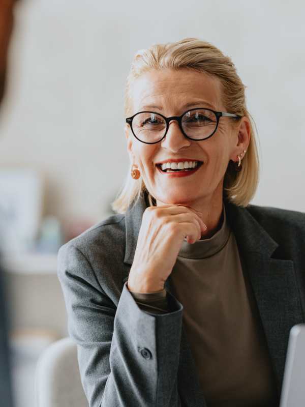 A smiling woman in a meeting at Peters Residential in Culver City, California