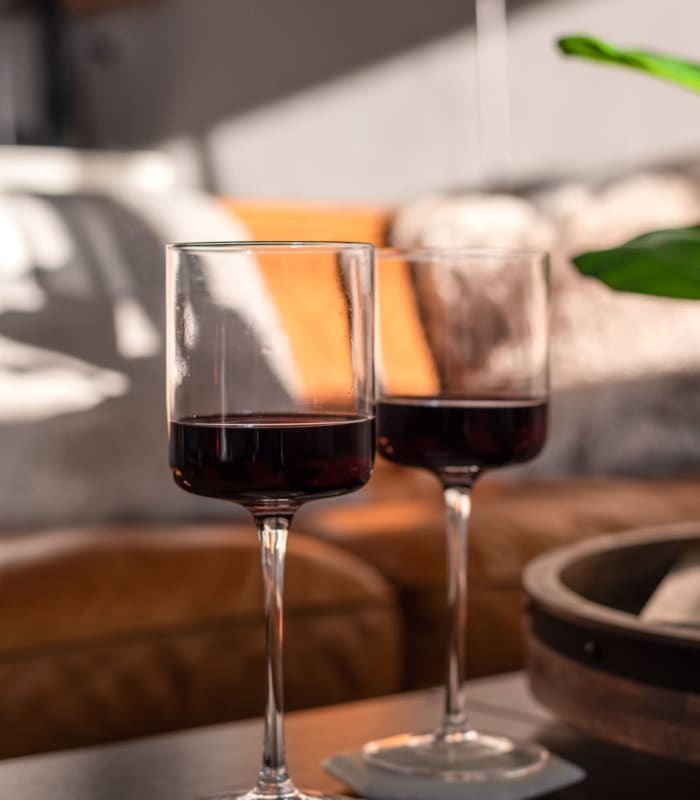 Two wine glasses in a model living space at Chisholm Pointe in Oklahoma City, Oklahoma