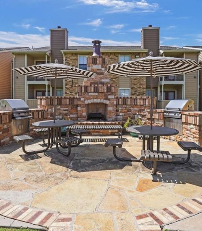the Outside fireplace and benches of Cimarron Trails Apartments in Norman, Oklahoma