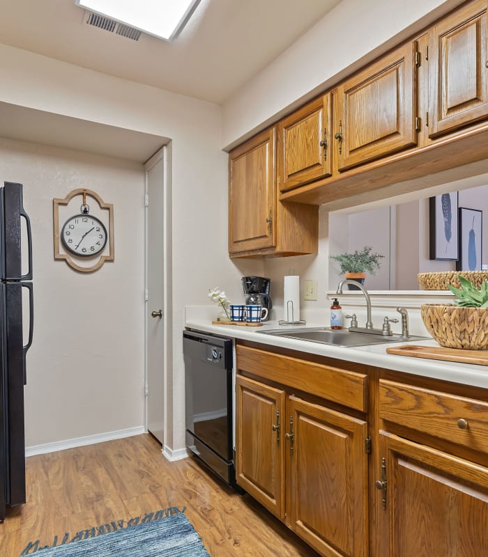 Kitchen with black appliances at Barrington Apartments in Tulsa, Oklahoma