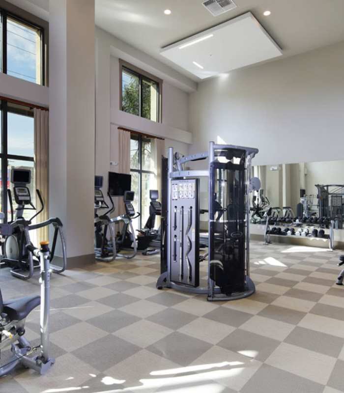 Resident working out in the gym at Varela Westshore Apartments in Tampa, Florida
