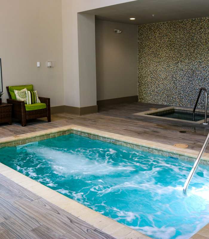 Resident soaking in the hot tub at Varela Westshore Apartments in Tampa, Florida