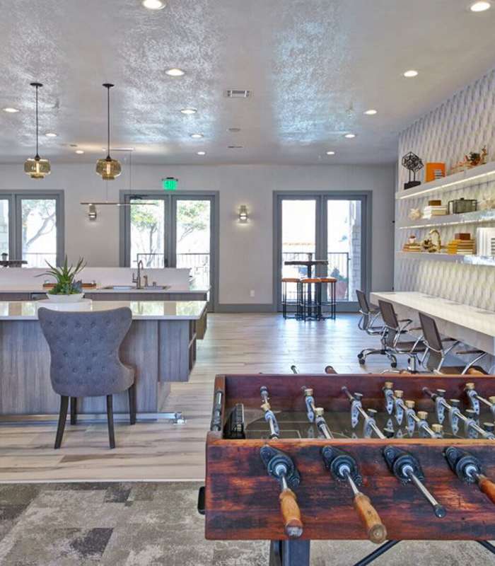 Resident Lounge with foosball table at Creekside At Legacy in Plano, Texas