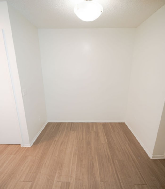 Empty walk-in closet nook with wood-look flooring at Huntington Reserve in Sanford, Florida