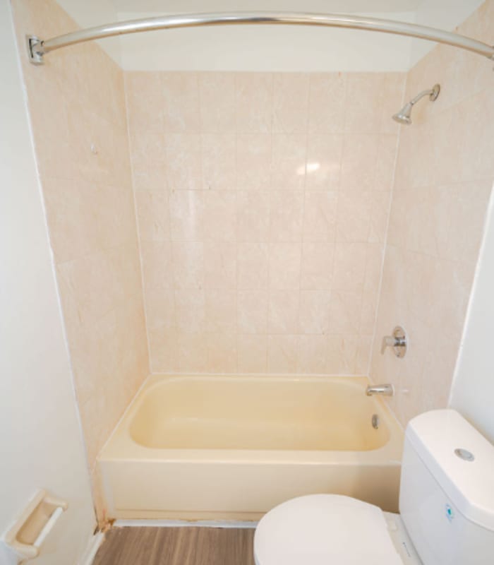 Bathroom with white vanity, lighted mirror, toilet and closet door at Huntington Reserve in Sanford, Florida