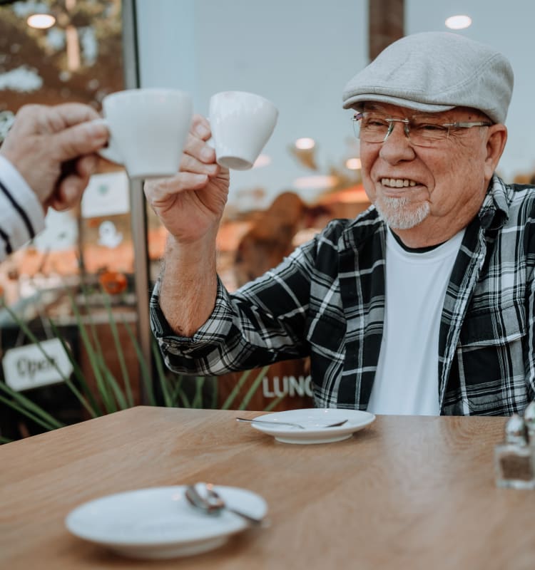 Resident having espresso at a cafe near at Meadow Walk Apartments in Miami Lakes, Florida