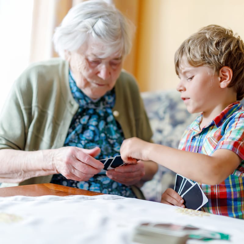 Grandmother and Grandson playing cards at Stoney Brook of Hewitt in Hewitt, Texas