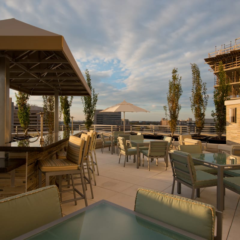 A rooftop lounge with bar seating at Solaire 1150 Ripley in Silver Spring, Maryland