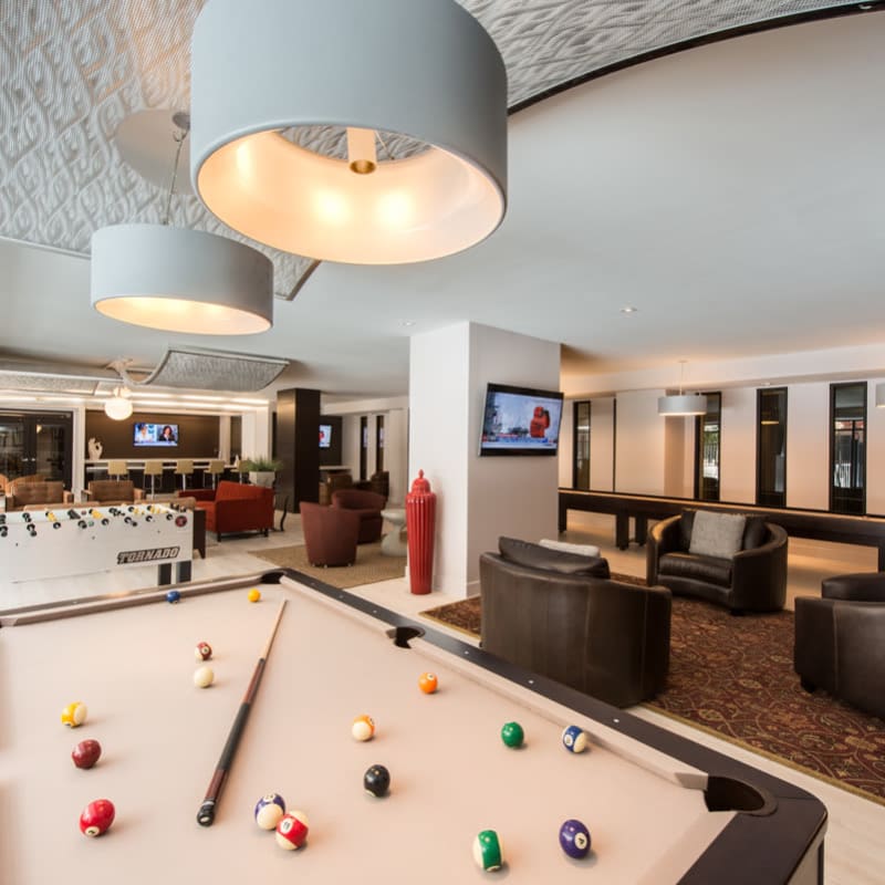 Lounge with Pool Table, Seating, and Other Games at in Silver Spring, MD