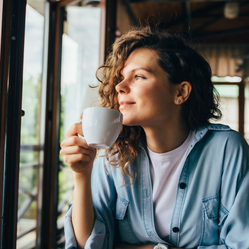 Resident enjoying her coffee at The Residences at Waterstone in Pikesville, Maryland