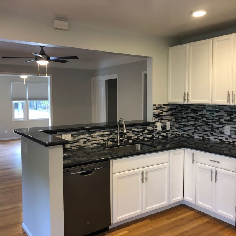 Model kitchen with black appliances at Hawthorne Apartments in Palo Alto, California