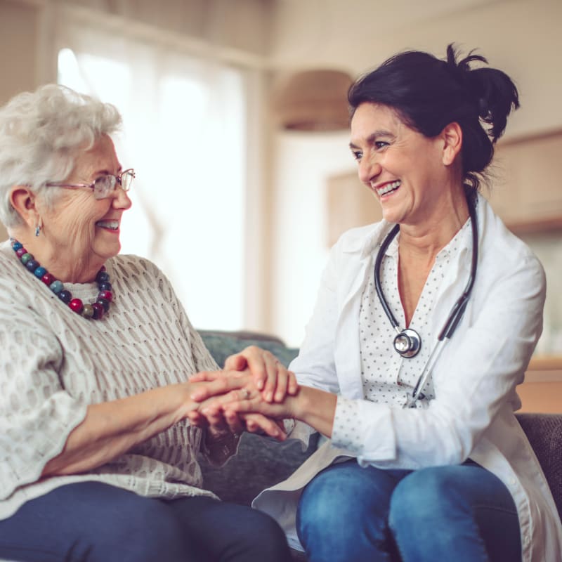 Resident with care provider at The Village of River Oaks in Houston, Texas