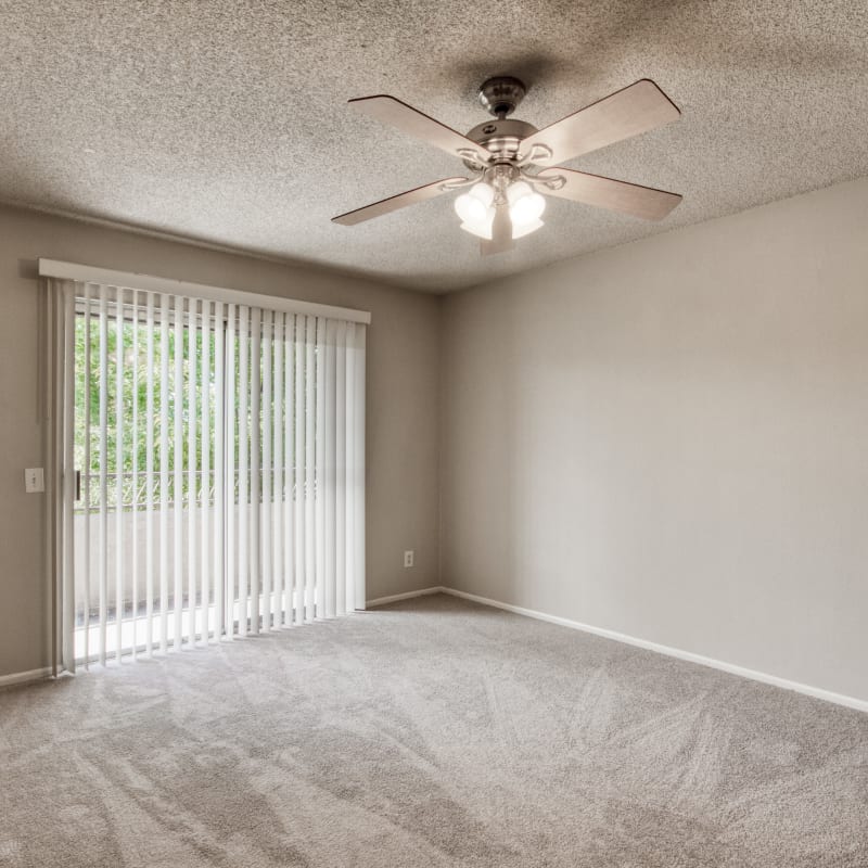 Glass door in an apartment living room at Casa Sierra in Riverside, California