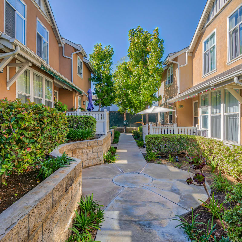Paved outdoor walkway with a meeting spot at Village Heights in Newport Beach, California