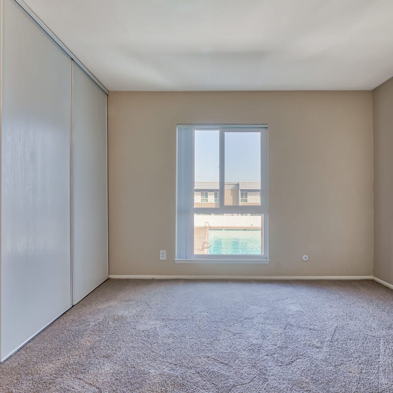 Carpeted bedroom at Sycamore Court in Garden Grove, California