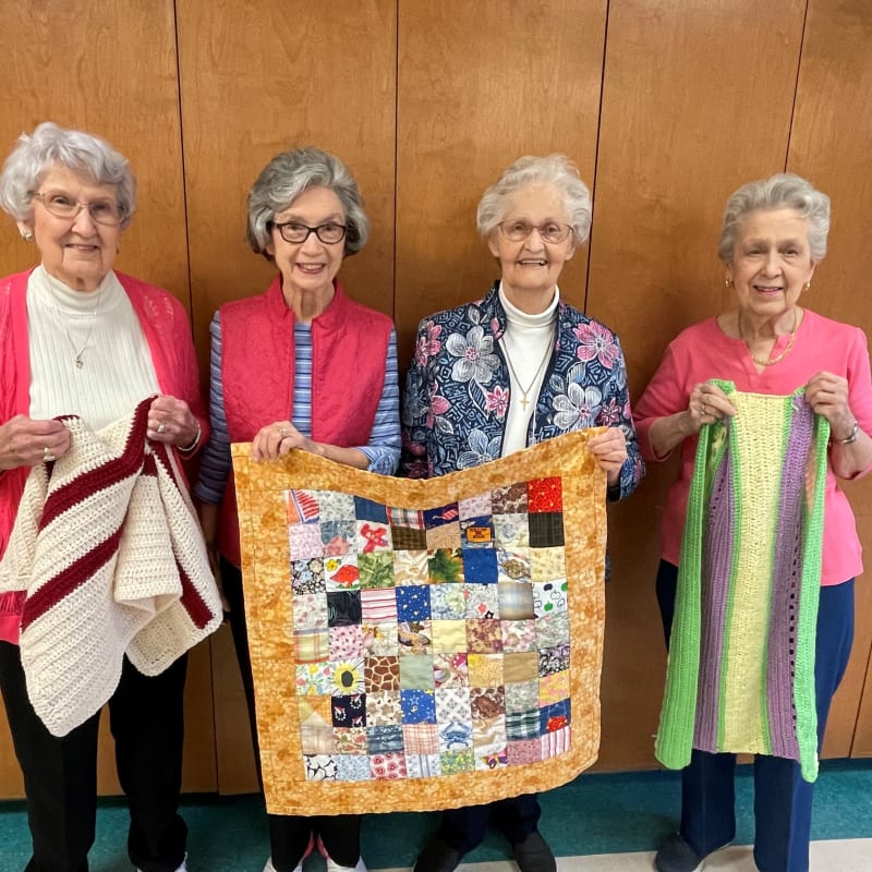 Residents presenting a quilt at The Columbia Presbyterian Community in Lexington, South Carolina