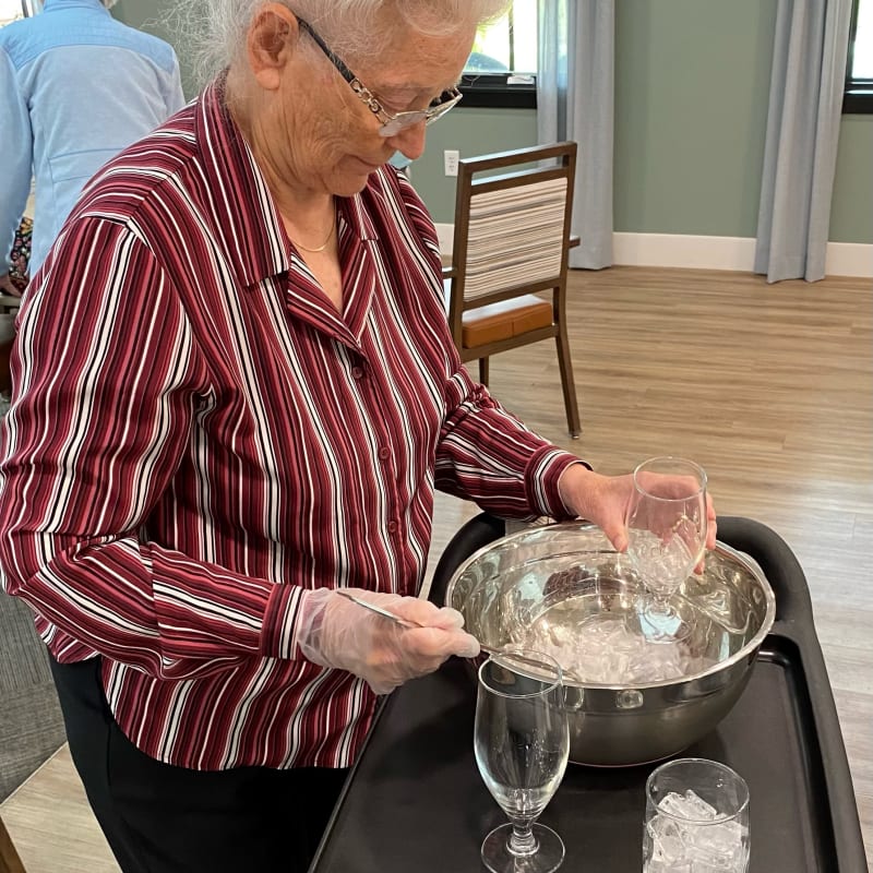 Resident serving drinks at a function in The Village at Summerville in Summerville, South Carolina