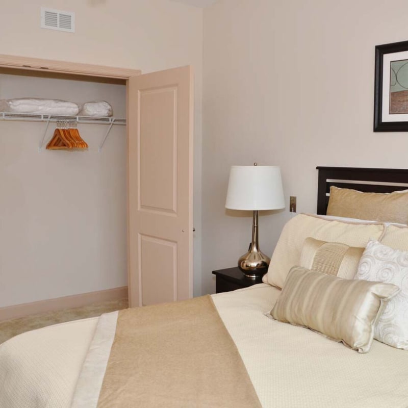 Modern bedroom with white accents at The Residences at Renaissance in Charlotte, North Carolina