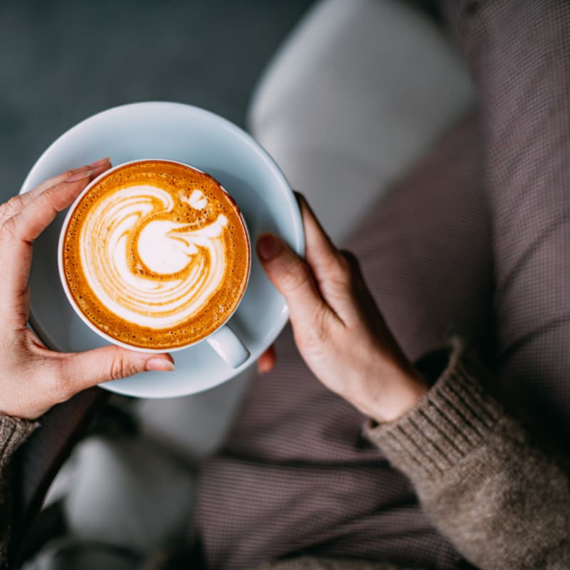 Resident drinking coffee at Lofts by the Lake in Greer, South Carolina