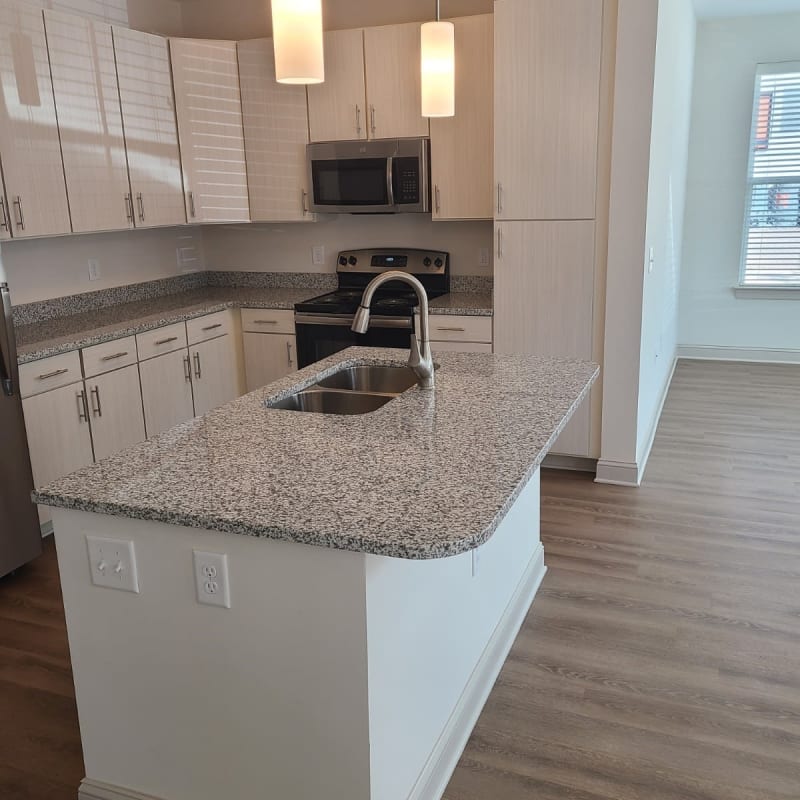 Model kitchen with granite countertops at Avion Point Apartments in Charlotte, North Carolina