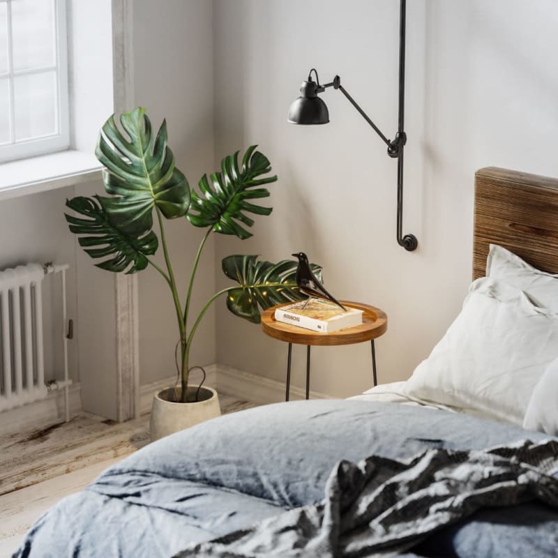 Modern bedroom with plants and wood accents at The Adair in Charlotte, North Carolina