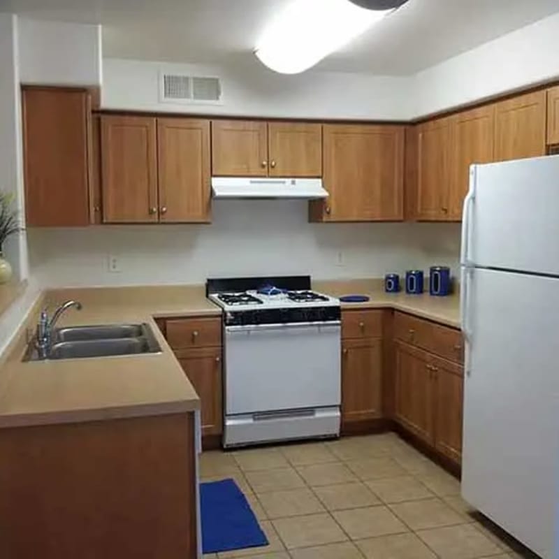 Kitchen with white appliances at Santa Fe Apartments in Bakersfield, California