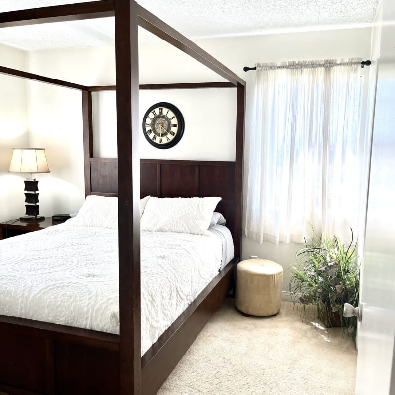 Model bedroom with soft carpet at Peppertree Place Apartments in Riverside, California
