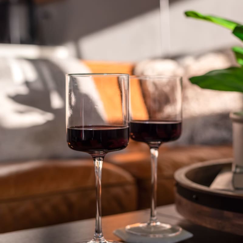 Glasses of wine on a coffee table at Maywood Villas in Maywood, California