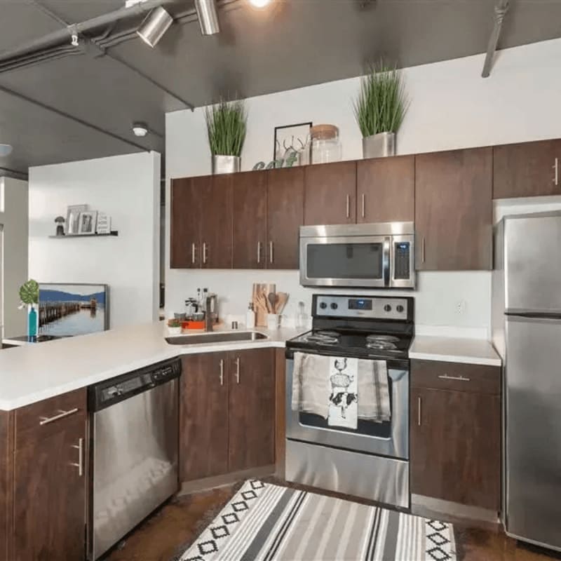 Kitchen with plank flooring and stainless-steel appliances at Argyle Apartments in Los Angeles, California