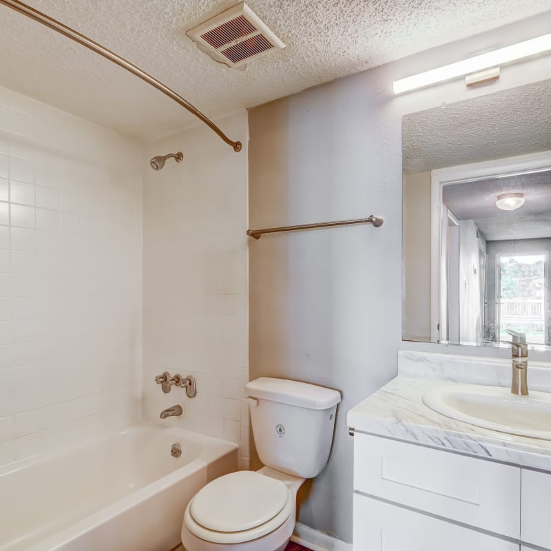 An apartment bathroom with a bathtub at The Park at Northside in Macon, Georgia