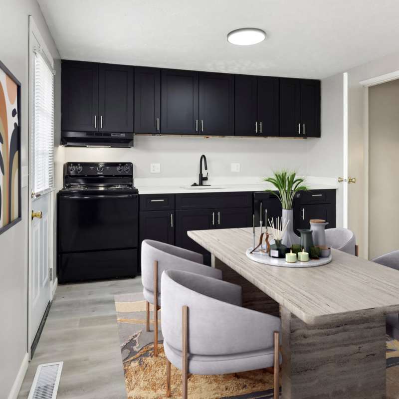 Modern kitchen with wooden cabinets and dining area at North Eden Townhomes in Columbus, Ohio