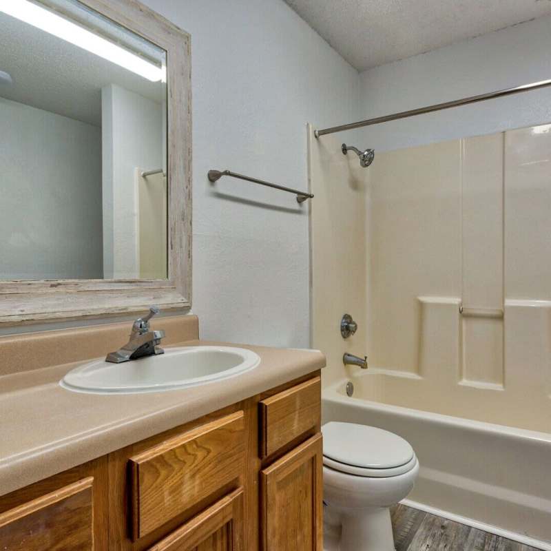 Bathroom with mirror, tub and storage space at Brookstone Park Of Seminole in Seminole, Oklahoma