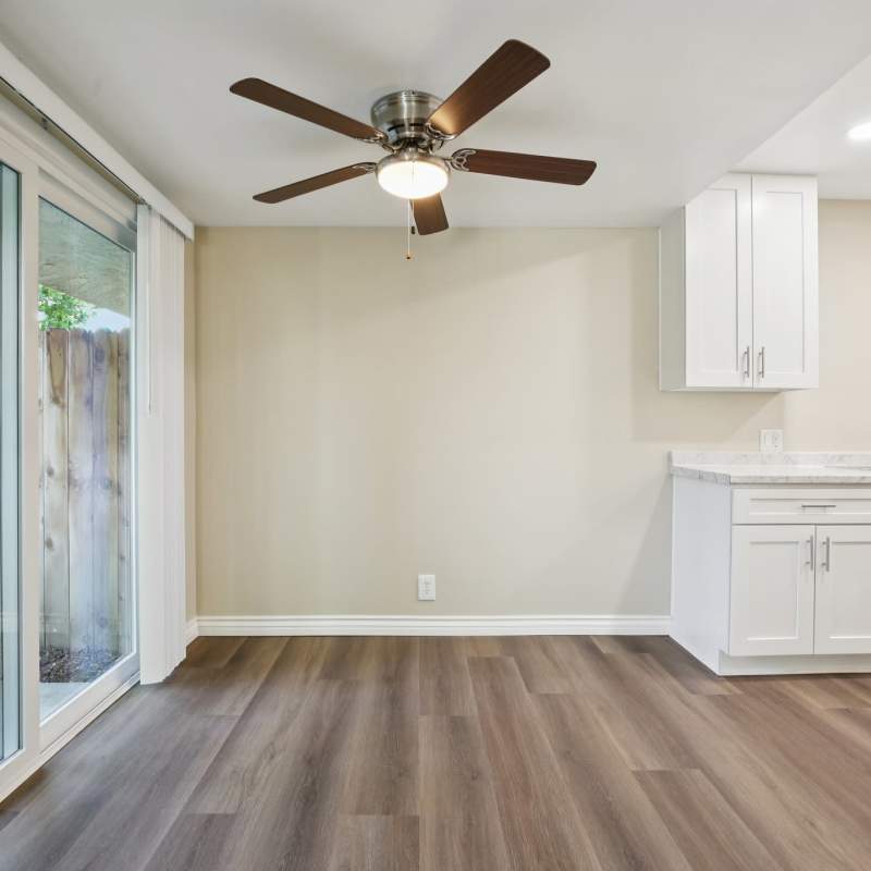 Spacious open living room layout with storage units at North Pointe Villas in La Habra, California